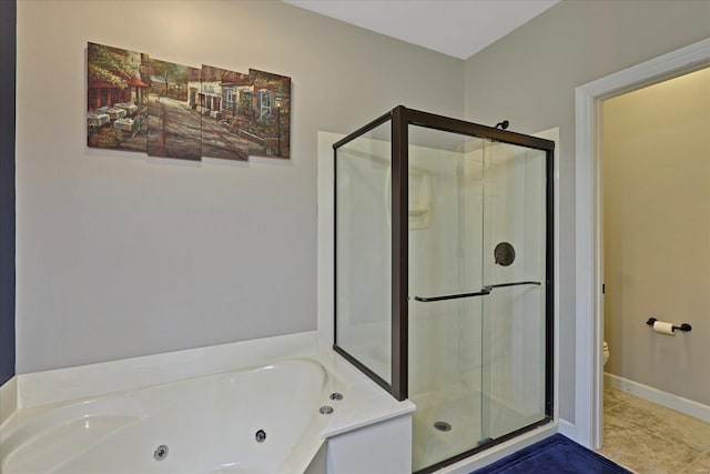 bathroom featuring a jetted tub, a shower stall, baseboards, and tile patterned floors