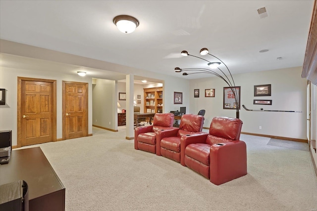 cinema with baseboards, visible vents, and light colored carpet