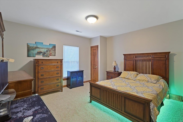 carpeted bedroom with baseboards and visible vents