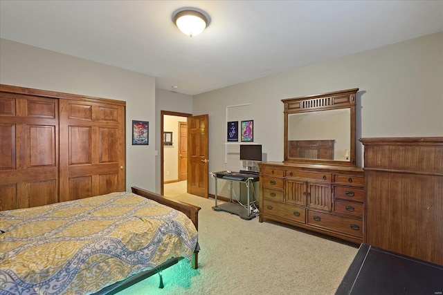 bedroom featuring a closet, light colored carpet, and baseboards