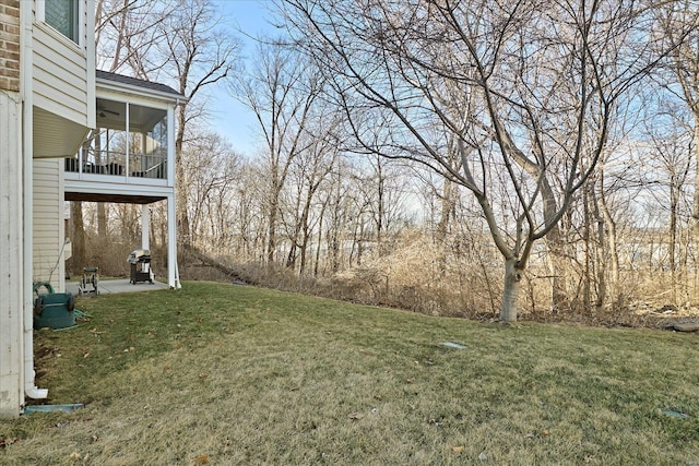 view of yard with a sunroom and a patio area