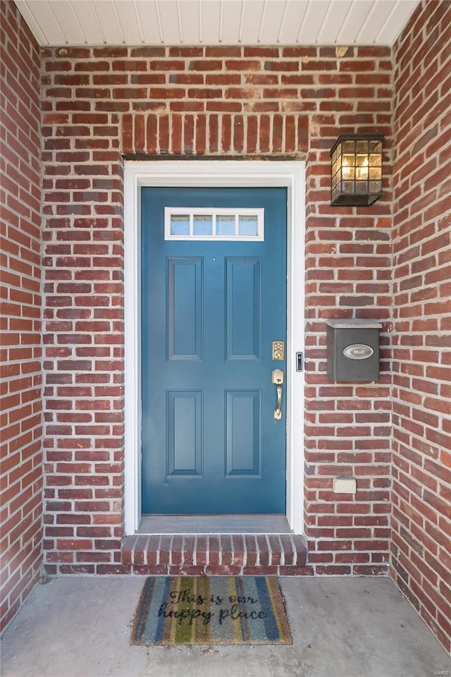 property entrance with brick siding