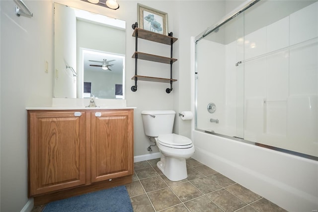 bathroom with tile patterned flooring, toilet, vanity, baseboards, and combined bath / shower with glass door