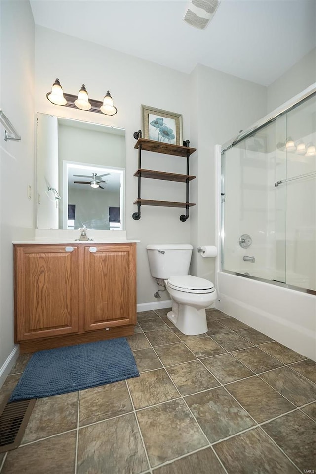 full bath with visible vents, toilet, combined bath / shower with glass door, vanity, and baseboards