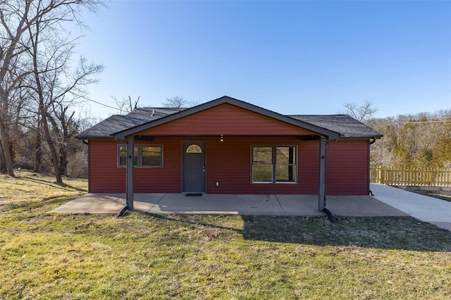 chalet / cabin featuring a front yard and fence