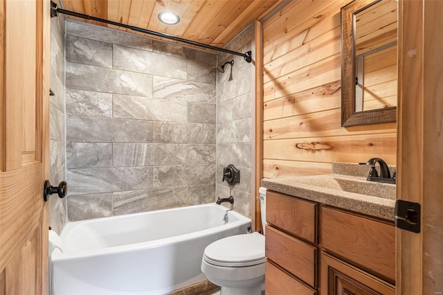 bathroom with toilet, wood ceiling, vanity, wood walls, and shower / bathing tub combination