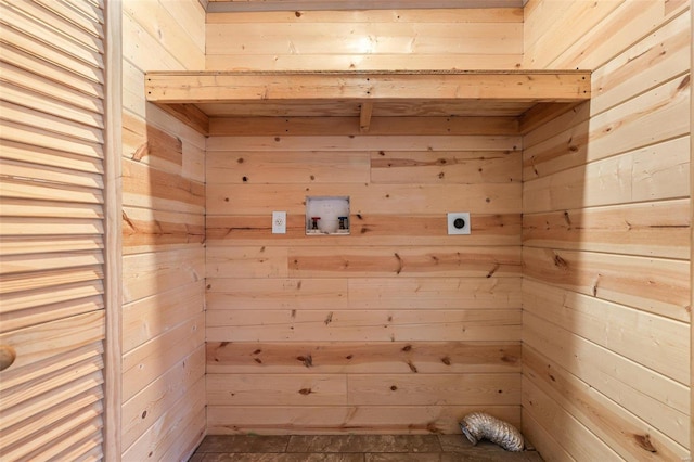 interior space with laundry area, a sauna, hookup for a washing machine, hookup for an electric dryer, and wood walls