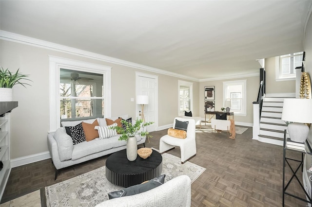 living area featuring stairs, crown molding, a wealth of natural light, and baseboards