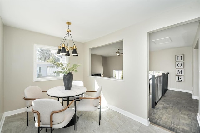 dining room featuring attic access and baseboards