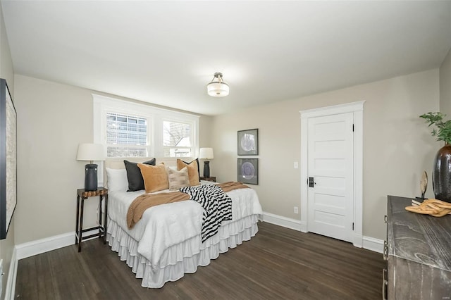 bedroom featuring dark wood-style flooring and baseboards