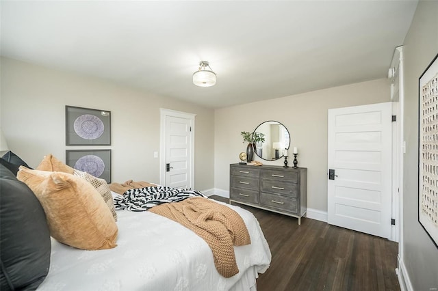 bedroom with dark wood finished floors and baseboards