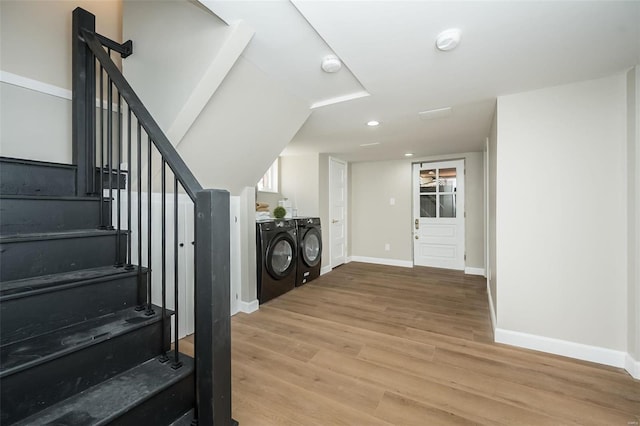 interior space featuring recessed lighting, baseboards, washing machine and clothes dryer, and wood finished floors