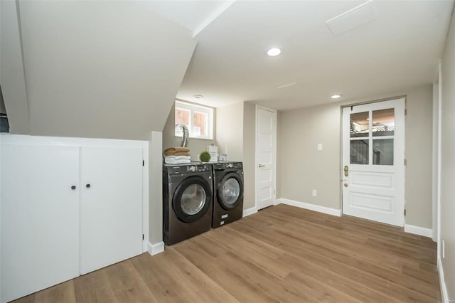 laundry area with laundry area, baseboards, light wood finished floors, and independent washer and dryer