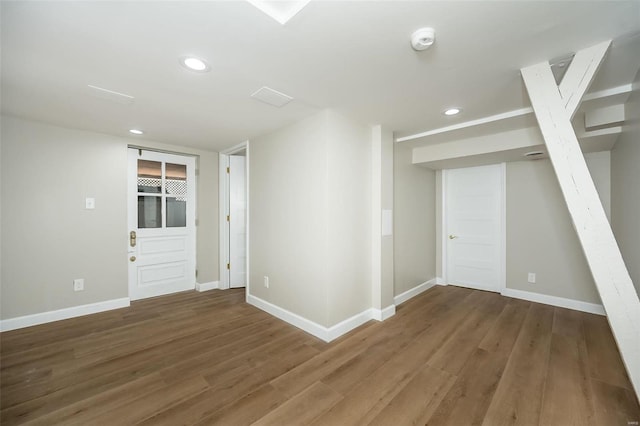 unfurnished room with recessed lighting, wood finished floors, and baseboards