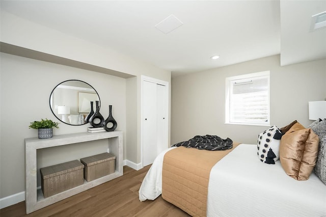 bedroom with recessed lighting, a closet, visible vents, wood finished floors, and baseboards