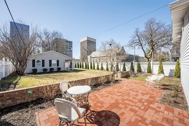 view of patio with a fenced backyard and an outdoor structure