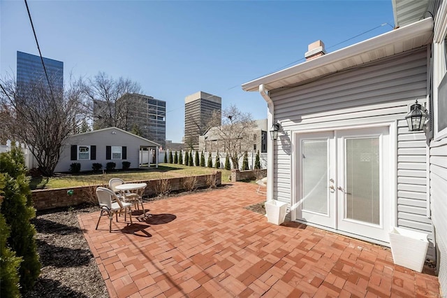 view of patio / terrace featuring french doors and fence