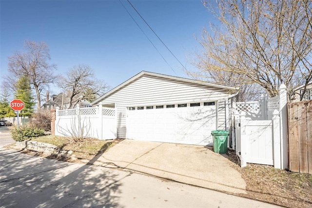 detached garage featuring a gate and fence