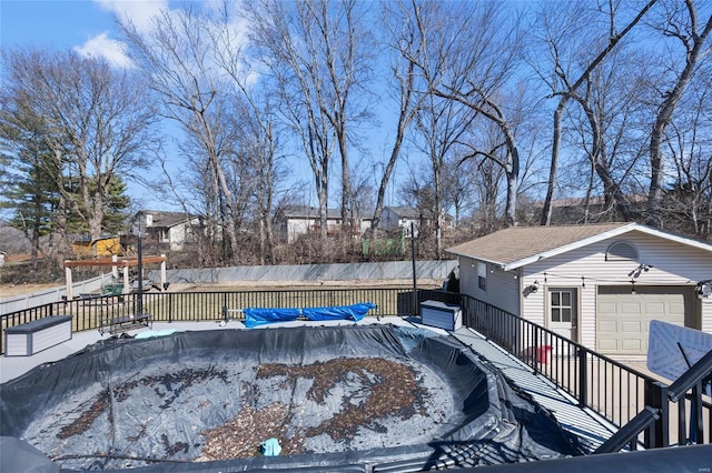 view of swimming pool featuring fence, a fenced in pool, and an outdoor structure