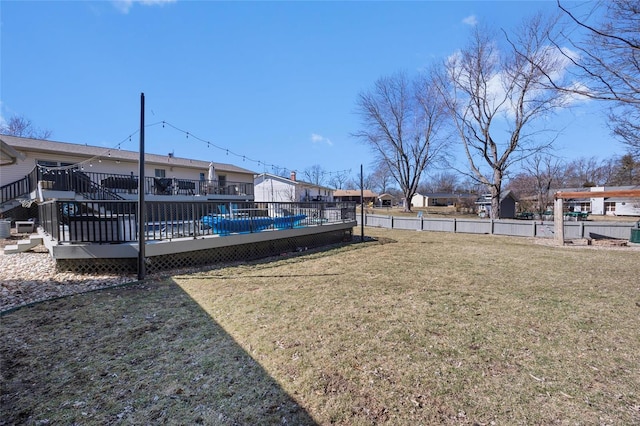 view of yard with a residential view, fence, and a deck