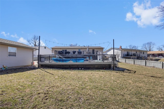 view of yard featuring fence and a deck