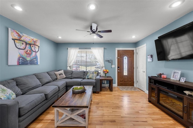 living area featuring recessed lighting, baseboards, ceiling fan, and light wood finished floors