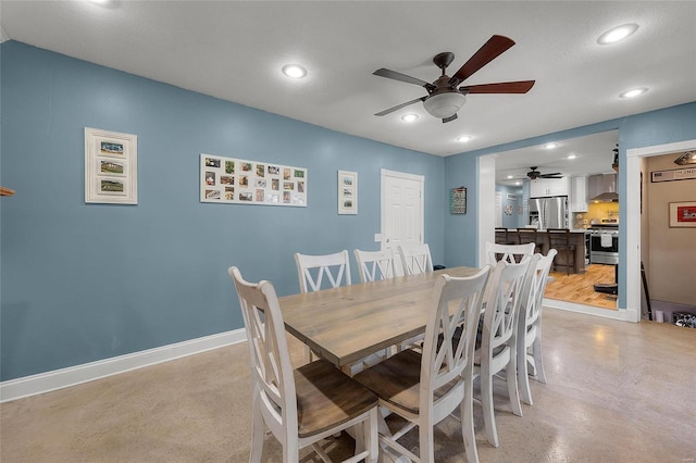 dining room featuring finished concrete flooring, recessed lighting, a ceiling fan, and baseboards