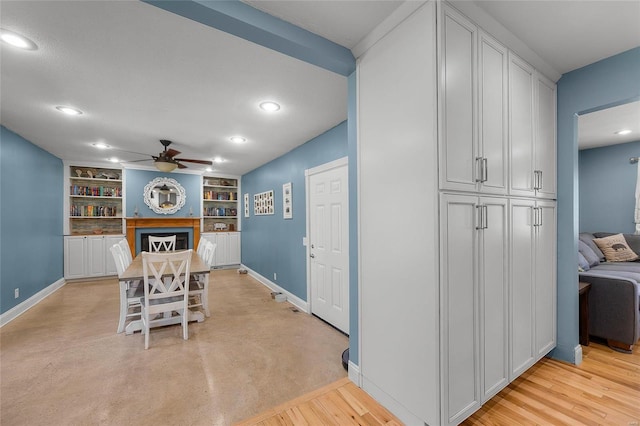 dining space with a ceiling fan, recessed lighting, a fireplace, and baseboards