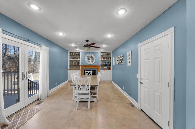 dining area featuring built in shelves, french doors, visible vents, and baseboards