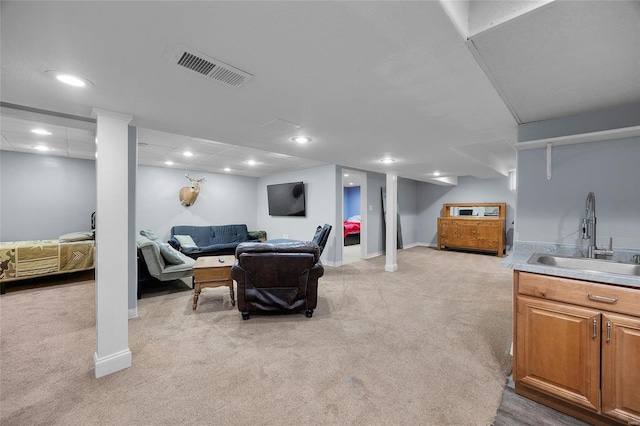 living room featuring baseboards, visible vents, and light colored carpet