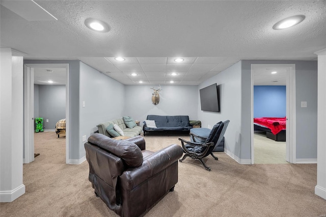 living room featuring light carpet, baseboards, and recessed lighting