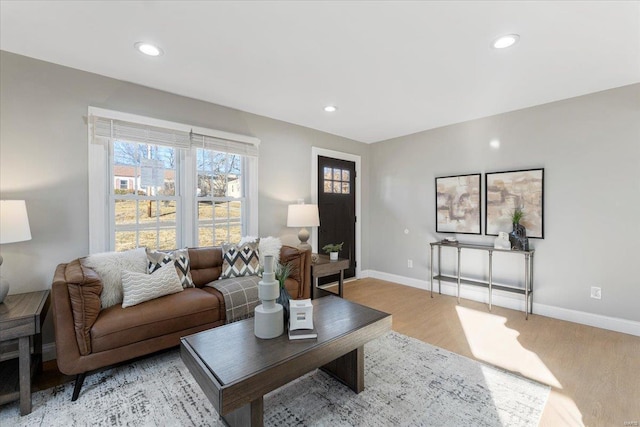 living room with recessed lighting, baseboards, and light wood finished floors