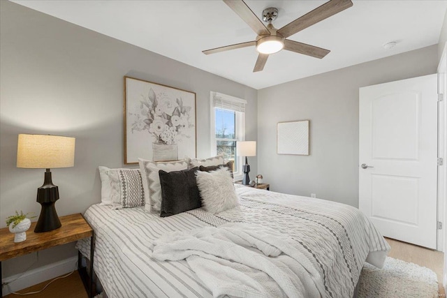 bedroom featuring a ceiling fan and light wood-type flooring