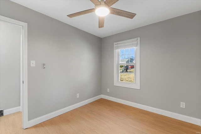 unfurnished room featuring visible vents, a ceiling fan, light wood-style flooring, and baseboards