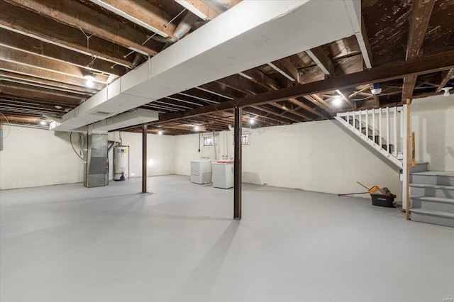 basement with separate washer and dryer, stairway, and gas water heater