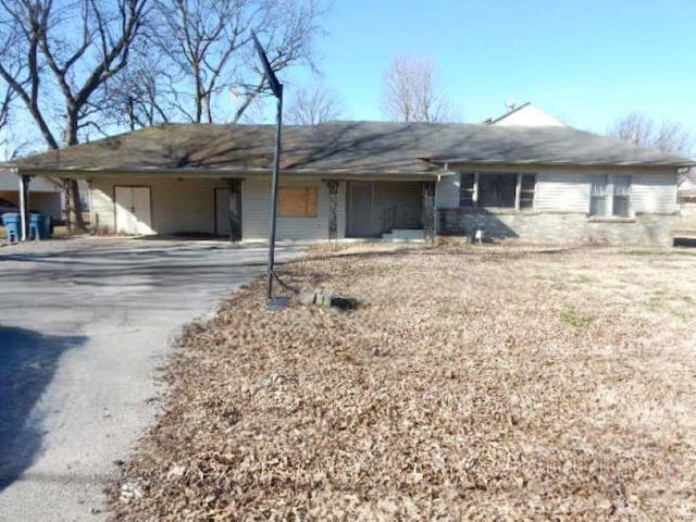 single story home featuring driveway and an attached carport