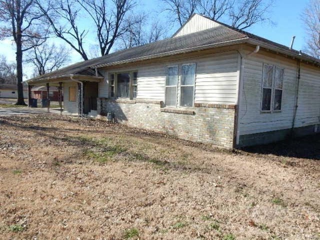 view of property exterior with brick siding