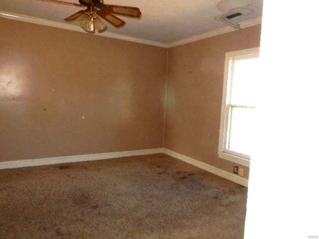 carpeted empty room featuring crown molding, baseboards, and ceiling fan