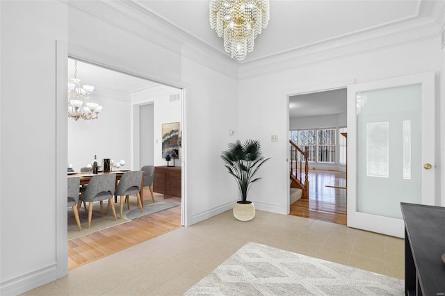 hallway with light tile patterned flooring, baseboards, stairs, ornamental molding, and an inviting chandelier