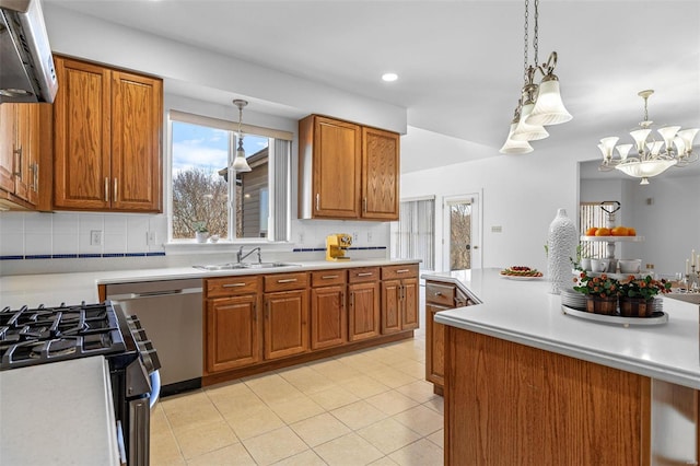 kitchen with stainless steel dishwasher, brown cabinets, a sink, and light countertops