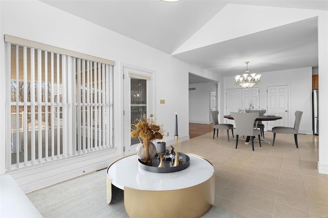 dining room with vaulted ceiling and an inviting chandelier