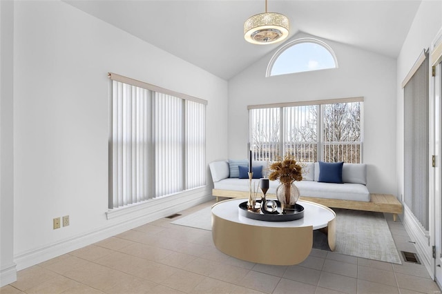 tiled living room featuring lofted ceiling and visible vents