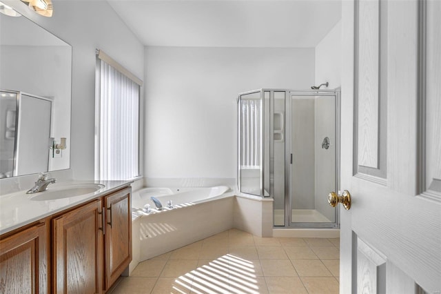 bathroom featuring a shower stall, tile patterned flooring, a bath, and vanity