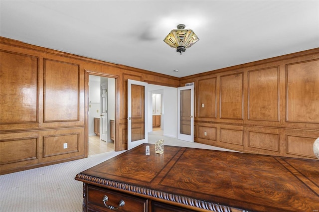 unfurnished bedroom with ensuite bath, carpet, and a decorative wall