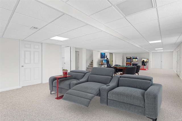 carpeted living room featuring a paneled ceiling, baseboards, visible vents, and stairway