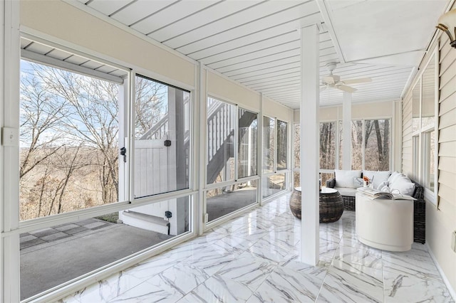 sunroom featuring ceiling fan