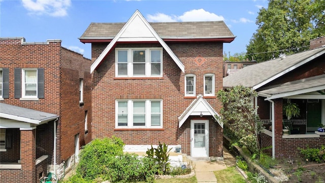 tudor-style house featuring brick siding