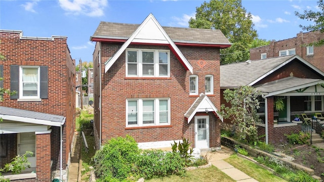 tudor-style house with brick siding