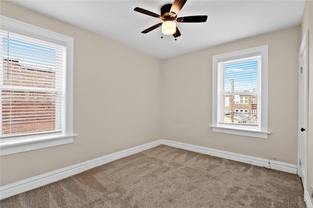 unfurnished room with carpet, ceiling fan, and baseboards