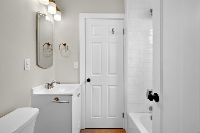 bathroom with toilet, shower / tub combination, and vanity